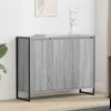 A gray wooden cabinet with black metal legs is shown against a white wall.