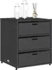 A black poly rattan cabinet with three drawers is shown against a white background. Decorative lanterns and a diffuser are placed on top of the cabinet. Náhled obrázku produktu