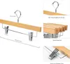 Collage of images showing wooden hangers with clips. Produktbild-Vorschau