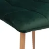 Close-up of the seat and legs of a dark green velvet chair. Anteprima dell’immagine prodotto