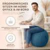 A man is sitting on a blue exercise ball in front of a desk with a laptop. Produktbild-Vorschau
