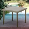 A square poly-rattan garden table with a beige top is placed on a patio with a pool and plants in the background. Anteprima dell’immagine prodotto