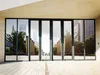A modern building entrance with large glass doors reflecting trees and buildings. Produktbild-Vorschau