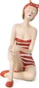 A decorative figurine of a woman in a striped swimsuit and a polka dot headscarf, sitting with her knees pulled up. Voir les images du produit