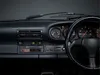 A close-up view of a car's dashboard, focusing on the radio and instrument cluster. Voir les images du produit