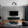 A modern living room with a TV, fireplace, and seating area. Produktbild-Vorschau