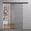 A modern interior scene featuring a sliding glass door and a bookshelf. Produktbild-Vorschau