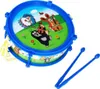 A toy drum with cartoon characters on it, along with two drumsticks. Produktbild-Vorschau
