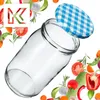 A glass jar with a checkered lid, surrounded by various vegetables and herbs. Produktbild-Vorschau
