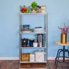 A four-tier metal shelving unit filled with kitchenware and decorative items, set against a light blue wall. Podgląd zdjęcia produktu