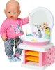A baby doll is standing next to a toy sink and mirror set. Produktbild-Vorschau
