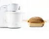 A white Bosch stand mixer with a large mixing bowl next to a loaf of bread in a wooden baking dish. Náhľad obrázku produktu