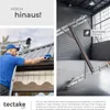 A man cleaning gutters on a roof, and a ladder in a warehouse. Produktbild-Vorschau