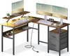 An L-shaped computer desk setup with two monitors, keyboards, and accessories. Náhled obrázku produktu
