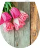 A bouquet of pink tulips is arranged on a rustic wooden surface. Produktbild-Vorschau