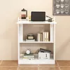 A white bookshelf with a laptop and coffee press on top, and books and a clock on the shelves. Podgląd zdjęcia produktu