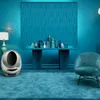 A room decorated in shades of blue, featuring a console table with decorative bottles and a textured wall panel. Podgląd zdjęcia produktu