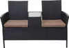A black poly-rattan bench with a small table in the center and cream cushions, shown against a white background. Produktbild-Vorschau