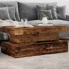 A rustic wooden coffee table in a living room setting, placed in front of a grey sofa. Podgląd zdjęcia produktu