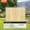 A bamboo fence is shown in a yard with a mountain landscape in the background. Voir les images du produit