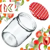 A glass jar and its lid are shown surrounded by various fresh vegetables and herbs. Anteprima dell’immagine prodotto
