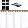 Four clear glass jars with bamboo lids and a sheet of chalkboard labels are displayed against a white background. Produktbild-Vorschau