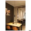 A modern restaurant interior with tables, chairs, and a pendant light. Produktbild-Vorschau