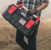 A person is carrying a toolbox outdoors. Anteprima dell’immagine prodotto