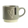 A single gray mug with a white heart design and a cream-colored base, set against a white background. Náhled obrázku produktu