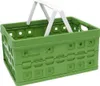 A green folding basket with white handles, shown from a slightly elevated diagonal angle. Produktbild-Vorschau