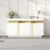 A modern white and gold sideboard against a marble-patterned wall. Anteprima dell’immagine prodotto