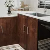 A close-up view of kitchen cabinets and countertop with a sink and faucet. Produktbild-Vorschau