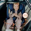 A young girl is sitting in a blue car seat in a car. Náhled obrázku produktu