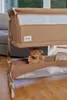 A close-up of a baby crib with a teddy bear inside. Náhľad obrázku produktu