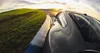 A car driving on a race track during sunset. Produktbild-Vorschau