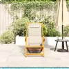 A lounge chair is placed on a patio next to a pool, with a fence and plants in the background. Produktbild-Vorschau
