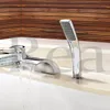 A modern bathroom faucet with a waterfall spout and a handheld showerhead, installed on the edge of a bathtub. The background features wooden wall paneling. Produktbild-Vorschau
