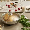 A close-up of a frying pan with chicken cooking, set on a table with festive decorations. Voir les images du produit