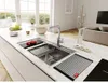 A modern kitchen island with a sink, faucet, and accessories, with a living area in the background. Podgląd zdjęcia produktu
