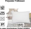 A white pillow is shown on a bed with care instructions and dimensions indicated. Produktbild-Vorschau