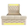 A beige upholstered bed frame with a tufted headboard and footboard, featuring integrated LED lighting. Náhled obrázku produktu