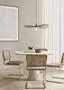 A dining set with a round table and chairs in a modern, minimalist room. Anteprima dell’immagine prodotto