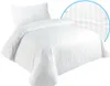 A white duvet cover and pillowcase set with subtle vertical stripes, presented on a white background. Produktbild-Vorschau