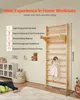 A child is climbing on a wooden wall-mounted gym set in a room with toys and furniture. Produktbild-Vorschau