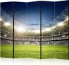 A panoramic view of a soccer stadium filled with spectators under bright stadium lights. Produktbild-Vorschau