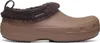 A single brown Crocs shoe with a fuzzy brown lining is shown against a white background.