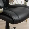 Close-up view of the seat and armrest of a black office chair with gold accents. Produktbild-Vorschau