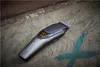 A Remington hair clipper is placed on a textured stone surface with some blue markings. Podgląd zdjęcia produktu