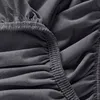 A close-up view of dark gray fabric with elasticized ruching, likely a fitted sheet. Produktbild-Vorschau