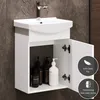 A white bathroom vanity with a sink and faucet, featuring two doors that are open to reveal bottles of soap and lotion inside. The background is a tiled wall. Produktbild-Vorschau